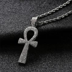 Make a statement with our Iced Out Ankh Cross Necklace, embodying the timeless symbol of eternal life. Meticulously crafted, this necklace features a stunning Ankh Cross adorned with sparkling details. Embrace the spirit of ancient Egypt as you wear this eye-catching and symbolic necklace." Metals Type: Copper Material: Cubic Zirconia Pendant Size: 51mm*19mm We ship worldwide to 185 countries! Please allow 1-2 business weeks for your order to arrive. Egyptian Ankh, Ankh Necklace, Ankh Cross, Key Pendant Necklace, Symbol Necklace, Mens Necklace, Hip Hop Jewelry, Key Pendant, Men's Necklace