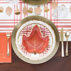 a place setting with plates, silverware and napkins