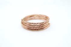 A Rose Gold Stackable Wrap Bracelet is a fashionable accessory designed to wrap around the wrist multiple times, creating a layered effect. It features a rose gold tone, which adds a warm, elegant hue, and is often made with materials like metal, beads, or crystals, making it versatile for both casual and formal wear. Rose Gold Stackable Beaded Bangle Bracelets, Rose Gold Bangle Beaded Bracelets For Party, Rose Gold Beaded Bangle Bracelets For Party, Rose Gold Beaded Bangle Bracelet For Party, Elegant Rose Gold Metal Beaded Bracelets, Rose Gold Stackable Jewelry For Party, Party Stackable Rose Gold Jewelry, Rose Gold Stackable Beaded Bracelets, Adjustable Rose Gold Braided Bracelets