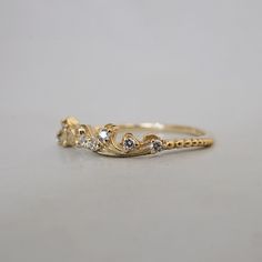 a gold ring with three diamonds on it