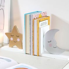 a bookend with a star and moon on it sitting next to an open book