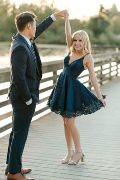 a man and woman dancing on a bridge