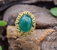 Vintage agate ring, a captivating design that lets you make a statement wherever you go. The green stone gives the ring a mesmerizing look. The design around the stones has yellower color to make the stone pop out even more. The design at the bottom of the ring is stunning, it really gives the ring the detail to set itself apart from other rings. A true piece of art. ■Design: Handcrafted agate ring ■Material: Solid 14k yellow gold ■Stamped: 585 Gold ■State: The ring is in excellent condition. ■R Vintage Green Opal Ring For Anniversary, Vintage Green Opal Ring, Vintage Agate Rings For Anniversary, Vintage Agate Gemstone Rings, Green Agate Oval Rings, Green Oval Agate Rings, Heirloom Green Opal Ring As Gift, Heirloom Style Green Opal Ring Gift, Heirloom Green Opal Ring Gift