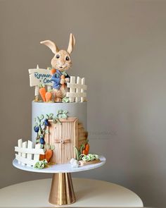 there is a cake that has a rabbit on it and carrots around the top