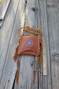 "This beaded leather handbag or crossbody bag is a good size for your phone, glasses or a few things to get you down the road.It is made of super soft leather, measures 6\" tall x 5 1/2\" wide and has a 48 inch braided shoulder strap. It is simple, light and functional. You can wear this bag over your shoulder or tie it around your waist... This item is MADE TO ORDER. You will not receive the piece you see in the photos, we will make one similar for you. Please allow 3 to 4 weeks to ship and tak Brown Crossbody Phone Bag For Personal Use, Brown Soft Leather Crossbody Phone Bag, Brown Crossbody Mobile Phone Bag, Small Brown Shoulder Bag For Everyday Use, Handmade Brown Pouch Phone Bag, Small Leather Shoulder Bag For Everyday Use, Leather Mobile Phone Bag For Festivals, Handmade Leather Phone Bag For Travel, Leather Pouch Phone Bag For Personal Use