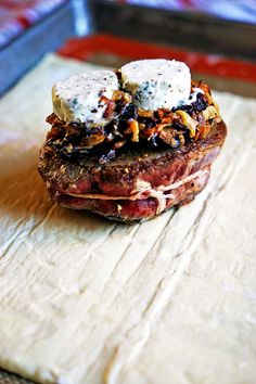 a piece of meat sitting on top of a wooden cutting board