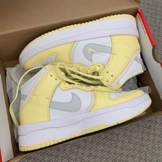 Nike Women’s Dunk High Top Sneaker In Yellow. Worn Once/Completely Brand New. Size 9 Women’s Revamping The Build Of The Heritage Silhouette Is The Nike Women's Dunk High Up 'White Citron Tint.' The White Leather Upper Is Secured By An Elongated Lacing System Reinforced By Yellow Leather Overlays At The Forefoot And Heel With A Standard Nike Tongue Tag And A Light Grey Swoosh, Overlaid With An Embroidered Yellow Mini-Swoosh. A Double-Stacked Foam Midsole Gives The High-Top A Lifted Look, While A Trendy Nike High-top Lace-up Sneakers, Trendy Nike Sneakers With Boost Midsole, Trendy Nike Custom High-top Sneakers, Sporty Yellow Custom Sneakers For Spring, Sporty Yellow High-top Sneakers With Boost Midsole, Trendy Yellow Sports Sneakers, Yellow Sporty Skate Shoes With Round Toe, Sporty Yellow Skate Shoes With Round Toe, Yellow Sporty Custom Sneakers For Spring