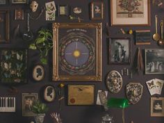 a wall covered in pictures and other items on it's side, including a clock