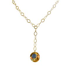 This stunning necklace showcases the captivating beauty of a blue sodalite gemstone layered over a gold circular pendant, elegantly dangling from a 2-inch lariat chain. The combination of the rich blue sodalite and the lustrous gold creates a striking contrast, resulting in a unique and eye-catching design. The blue sodalite gemstone is known for its deep and intense blue color, reminiscent of the serene ocean or the vast night sky. Its natural patterns and variations make each stone truly one-o Blue Gemstone Lariat Necklace, Blue Lariat Jewelry With Adjustable Chain, Blue Lariat Necklace With Adjustable Chain, Blue Long Lariat Necklace With Adjustable Chain, Gold Gemstone Lariat Necklace With Long Drop, Gold Gemstone Lariat Necklace, Gold Lariat Gemstone Jewelry, Blue Gold-plated Chain Necklace With Adjustable Chain, Blue Hammered Dangle Jewelry