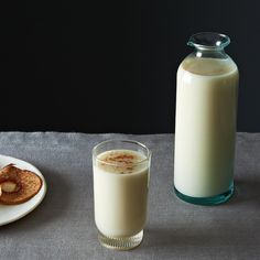 a glass of milk next to a bottle of milk