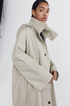 Our take on a classic autumnal silhouette, the Parker jacket is crafted in 100% waxed cotton. This jacket has a relaxed silhouette ideal for layering over knitwear, with a cotton cord drawstring through the waist that can be adjusted for varying styling options. This jacket has wide, long sleeves that can be folded back to reveal a contrast ivory lining. This jacket has a high standing collar that can be worn loose or secured by two dome closures. It also has a detachable hood that is finished with a cotton cord drawstring and can be adjusted for the desired fit. This jacket can be worn loose or done up, secured by contrasting black dome closures down the centre front. Size Model is 5'10 and wears a size 8. Please see key measurements in cm below: Half chest (at underarm): 6/68 8/70 10/72 Parker Jacket, The Body Book, Luxe Life, Standing Collar, Japan Design, Clarks Originals, Denim Design, Detachable Hood, Big Love