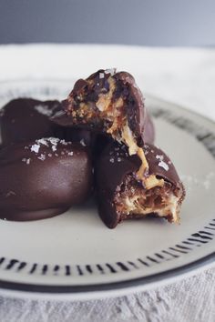 three pieces of chocolate on a white plate