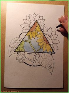 a drawing of sunflowers and leaves with a triangle in the middle, on top of a piece of paper