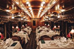 a dining car on a train with tables and chairs set up for two people to eat