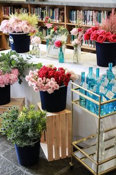 many different types of flowers in vases on a table