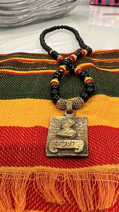 Black 10mm wood beads with Rasta colours and pave crystals hangs approximately 34 inch with a solid brass gold pendant of his majesty Haile Selassie Haile Selassie, Rasta Colors, Hair Pack, Spice Recipes, Brass Gold, Shell Necklaces, Chain Styles, Wood Beads, Gold Pendant