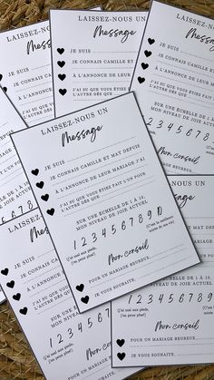 wedding program cards with hearts on them sitting in a wicker basket next to each other