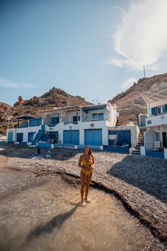 a woman standing in front of some houses