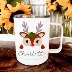 a white coffee mug with a reindeer head on it