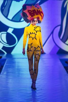 a model walks down the runway in a costume designed to look like a cartoon character