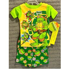 Get Your Little Boy Ready For Bed With This Adorable Teenage Mutant Ninja Turtles Pajama Set. Designed For Boys 12 Months Old, This Set Includes A Colorful Top And Pants, Both Featuring His Favorite Tmnt Characters. The Set Is Made From Soft And Comfortable Materials, Perfect For A Good Night's Sleep. Ideal For Baby And Toddler Clothing, This Set Is A Must-Have For Any Tmnt Fan. Whether He's Settling Down For The Night Or Just Lounging Around The House, These Pajamas Are Sure To Keep Him Comfort Cute Green Bedtime Set, Cute Green Playtime Sets, Casual Yellow Bedtime Sets, Green Fitted Sets For Playtime, Yellow Cotton Playtime Sets, Cute Yellow Sleepover Sets, Playful Yellow Bedtime Sets, Yellow Cute Sleepover Sets, Tmnt Characters