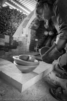 a man is working on a bowl in his workshop