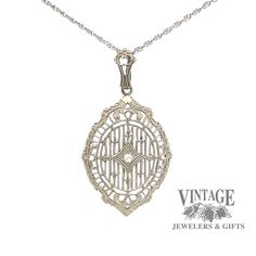 The detail of this antique vintage 14 karat white gold filigree pendant is noteworthy as it offers a shield shape with filigree spokes from top to bottom in a linear design. The filigree is joined by 6 small fleur-des-lis and 2 floral designs. The .02 carat single cut SI quality diamond is illusion set in a small diamond shape inset in the center of the pendant while the scallopped and reeded edge gives it even more character. The pendant is suspended from a milgrain etched bale on a 18" fine op Linear Design, Filigree Pendant, Gold Filigree, Diamond Shape, Rope Chain, Quality Diamonds, Floral Designs, Spring Rings, Diamond Pendant