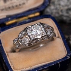 an antique diamond ring sits in its box