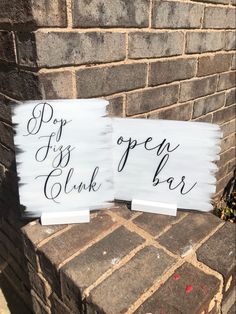 two white signs with black writing on them