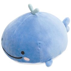 a blue whale stuffed animal with a smile on it's face and nose, laying down