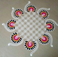 an intricate design on the floor in white and pink colors with black, yellow and red accents