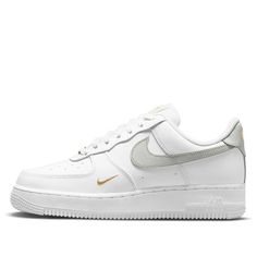 The Nike Air Force 1 'White Light Silver' is a classic silhouette with a modern twist. Crafted from white leather, the sneaker features signature perforations on the toe box and side panels. Detailed with gray leather Swooshes, tongue label, and gold embroidered brand logo on the side and heel, this sneaker is finished with a durable white rubber sole. Perfect for everyday wear, this timeless design is inspired by the original Air Force 1 series and is sure to be a staple in any wardrobe. (AF1/S Gold Nike Shoes, Nike Air Force Low, Tenis Air Force, White Air Force Ones, Sneakers Air Force, Gray Nike Shoes, Air Force Women, White Air Forces, Nike Shoes Air Force