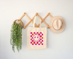 "Aesthetic Smile Tote Bag, Checkered Summer Tote Bag, Trendy Cool Canvas Bag, Positivity Bag, Tumblr Tote Bag, Canvas Bag, Zippered Tote Bag Welcome to ZeeShirtUS! I am happy to see you in my shop. My main purpose is to meet you with a high-quality product. The regular and zippered tote bags are perfect for just about anything. Grocery bag, school bag, beach bag, a beautiful fashion bag all year round, etc. The design is only printed on one side of the bag.  How To Order 1. Please, check and rev Trendy Rectangular Canvas Bag, Trendy Square Canvas Bag, Trendy Rectangular Canvas Gift Bag, Trendy Rectangular Canvas Bag For Gifts, Trendy Multicolor Canvas Bag For Gifts, Aesthetic Smile, Zippered Tote Bag, Summer Tote Bag, Summer Tote Bags