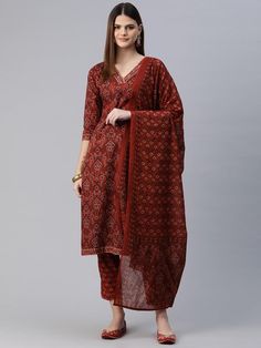 Women Floral Printed Regular Pure Cotton Kurta with Trousers & With Dupatta PRODUCT DETAILS  Red printed Kurta with Trousers with dupatta Kurta design: Floral printed Straight shape Regular style V-neck, three-quarter regular sleeves Zari detail Calf length length with straight hem Pure cotton machine weave fabric Trousers design: Printed Trousers Elasticated waistband Drawstring closure Size & Fit Size worn by the model: S Chest: 32" Waist: 29" Hips: 38" Height: 5'8" Material & Care Kurta Fabric: Cotton Bottom Fabric: Cotton Dupatta Fabric: Cotton Wash Care: Machine Wash Specifications Sleeve Length Three-Quarter Sleeves Top Shape Straight Top Type Kurta Bottom Type Trousers Dupatta With Dupatta Top Pattern Printed Top Design Styling Regular Top Hemline Straight Top Length Calf Length Nec Red Traditional Drape Sets With Printed Motifs, Red Sets With Printed Motifs In Traditional Drape, Red Sets With Printed Motifs And Traditional Drape, Red Printed Motifs Sets For Navratri, Fitted Red Palazzo Set With Printed Motifs, Fitted Red Bandhani Print Palazzo Set, Red Cotton Palazzo Set With Traditional Drape, Traditional Red Printed Sets, Traditional Fitted Sets With Printed Border