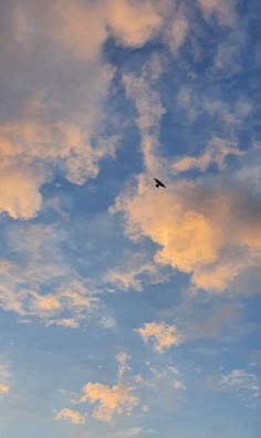 an airplane is flying in the sky at sunset