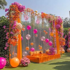 an outdoor wedding setup with balloons and flowers