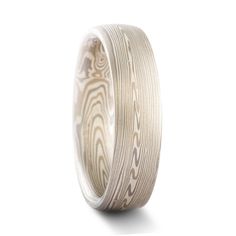 "This demure and 5mm Mokume Gane ring is shown in the Vortex pattern and Smoke Palette, with a low dome profile, and a lightly etched finish. This makes for a lovely combination, the swirling pattern in this all silver/white palette invoking the imagery of coiling wisps of smoke wafting from a recently snuffed flame. The Smoke palette features a three metal combination of 14k White Gold, Palladium, and Sterling Silver. Pattern: Vortex Palette: Smoke Finish: Lightly Etched Profile: Low Dome Width Modern Etched Jewelry For Wedding, White Wedding Jewelry With Engraving Option, White Jewelry With Engraving Option For Wedding, Mokume Gane Ring, White Palette, Mokume Gane, Black Box, Size 10 Rings, Precious Metals