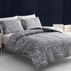 a bed with grey and orange comforters in a room