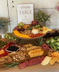 a table filled with lots of different types of food on it's trays