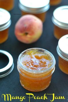 several jars filled with peach jam sitting next to an apple