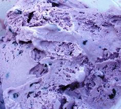 an ice cream dish with blue and purple toppings