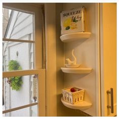 the corner shelves in this kitchen are filled with books and other things to put on them