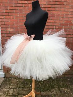 "This listing includes an ivory tutu with an ivory satin bow also includes the rose gold accent bow clip. This listing if for waist sizes 45 1/2 up to 55 1/2\" can be made larger if interested contact me for a special listing. Other colors also available. The ivory tutu with the rose gold bow clip has a longest length of 18\" and top layer of 13\". The ivory tutu with just the satin bow is the 13-18\" length range with a longest layer of 15\" and top layer of 12\". Tutu can be all one length or White Princess Tutu Dress With Bow, White Princess Style Tutu Dress With Bow, Cream Tulle Skirt Tutu Dress For Baptism, White Tulle Petticoat For Party, White Balletcore Skirt For Party, Cream Tulle Tutu Dress For Wedding, Fitted White Tutu Dress With Bow, White Fitted Tutu Dress With Bow, Fitted Cream Tutu Dress With Tulle Skirt