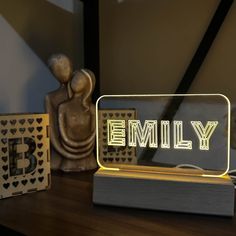 an illuminated sign with the word family on it sitting next to two small wooden blocks