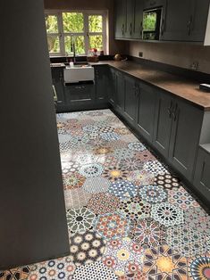 the kitchen floor is decorated with colorful tiles