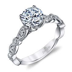 a white gold engagement ring with an intricate design