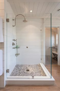 a walk in shower sitting inside of a bathroom