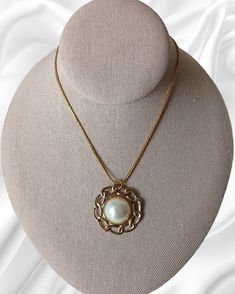 Vintage 1970's Monet Pearl Half Sphere Retro Design Pendant Gold Tone Necklace. This statement jewelry piece is elegant for formal, those dinner-dancing nights out, cruise wear or part of a work wardrobe. Classic in design with a chain measuring 18 inches in length unclasped, pendent measures 1 3/8 inches in diameter by 1/2 inches thick. This piece has some pealing on the back but is in overall good vintage condition. Retro Round Necklace For Formal Occasions, Retro Round Necklaces For Formal Occasions, Elegant Medallion Necklaces For Evening, Vintage Pearl Pendant Necklace For Formal Occasions, Vintage Formal Necklace With Pearl Pendant, Vintage Pearl Pendant Jewelry For Evening, Formal Costume Jewelry Necklace With Pearl Pendant, Elegant Medallion Necklace For Formal Occasions, Vintage Jewelry With Pearl Charm Round Pendant