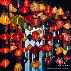 many colorful lanterns are hanging from the ceiling