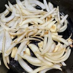 onions being cooked in a skillet with oil